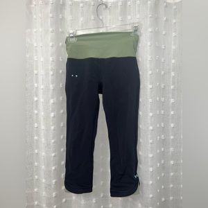 Cropped black Under Armor leggings with sea foam green waistband